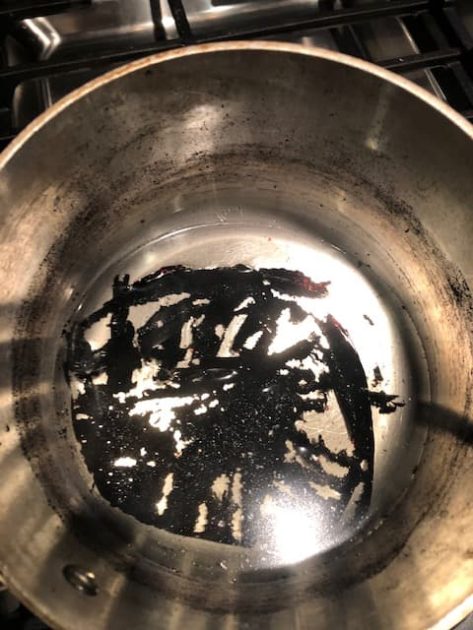 Pieces of burnt sugar lifting from bottom of pan