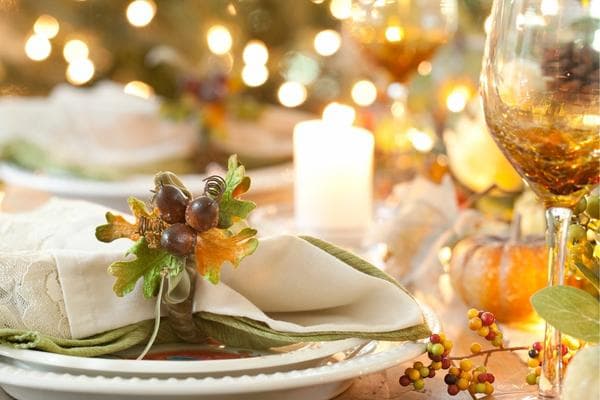 Thanksgiving table setting with acorns and pumpkins