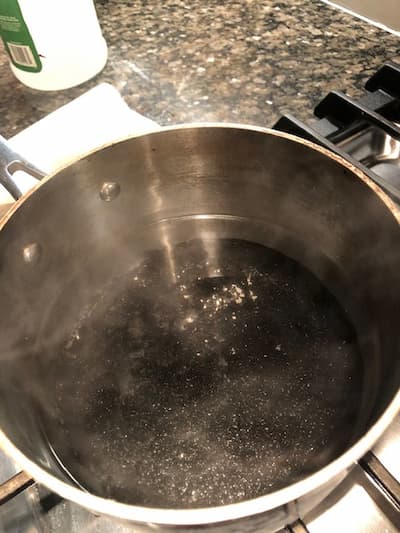 Vinegar working to clean a burnt pot
