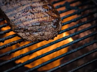 Sizzling steak on a charcoal grill