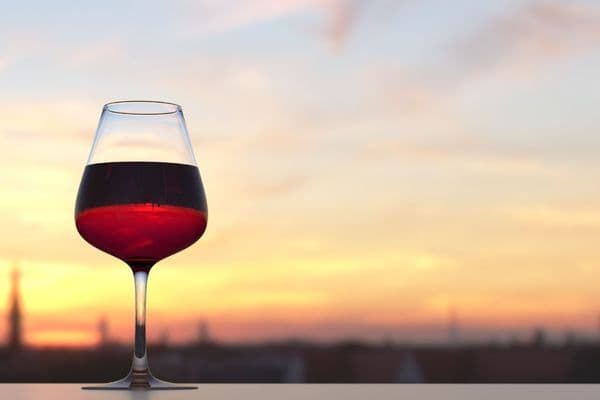 glass of red wine enjoyed at sunset