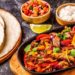 Sizzling platter of beef fajitas to cook for Father's Day