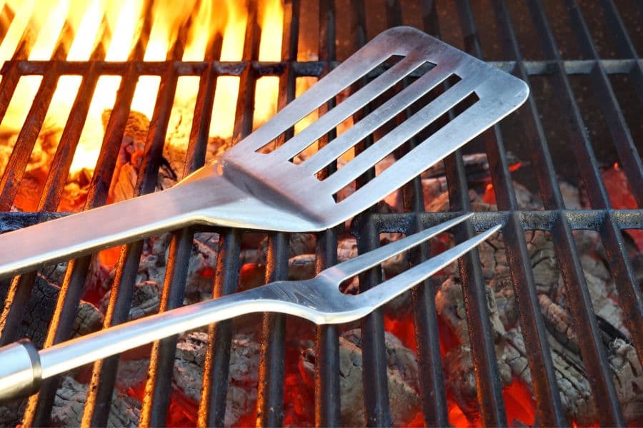 Best Grill Tools featured image with spatula and fork on grill grates