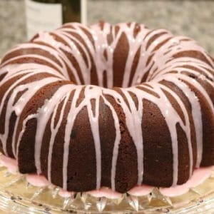 Dark Chocolate Bundt Cake with Red wine glaze on a glass cake stand