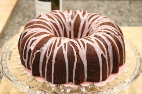 Dark Chocolate Bundt Cake with Red wine glaze on a glass cake stand