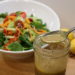 Vinaigrette dressing with a bowl of salad for a Mother's Day Brunch Idea