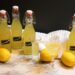 Limoncello in bottles and glasses to enjoy or gift