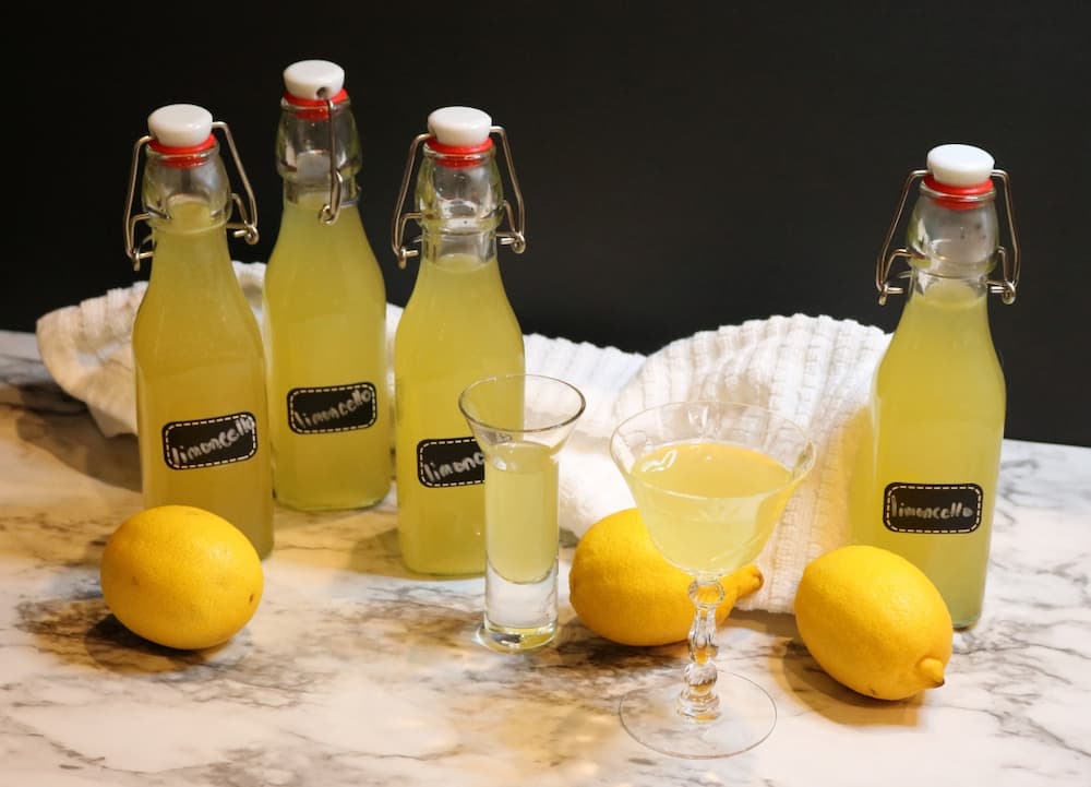 Limoncello in bottles and glasses to enjoy or gift