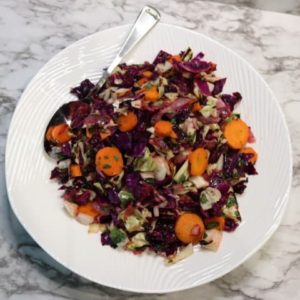 overhead view of grilled coleslaw with dressing in bowl